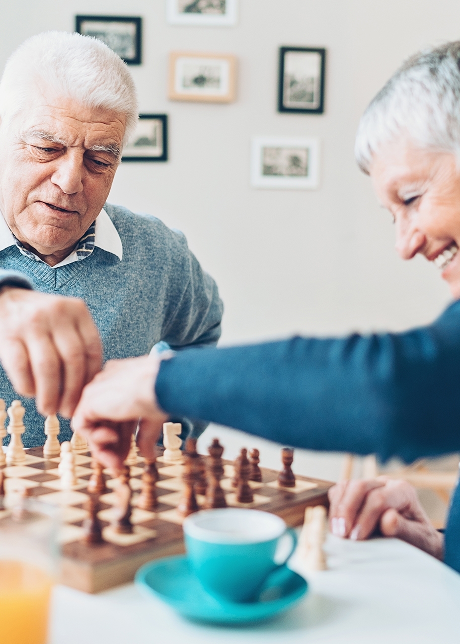 Couple Playing Chess at table